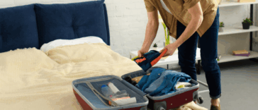 young man packing a suitcase