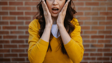 surprised woman with hands on her face