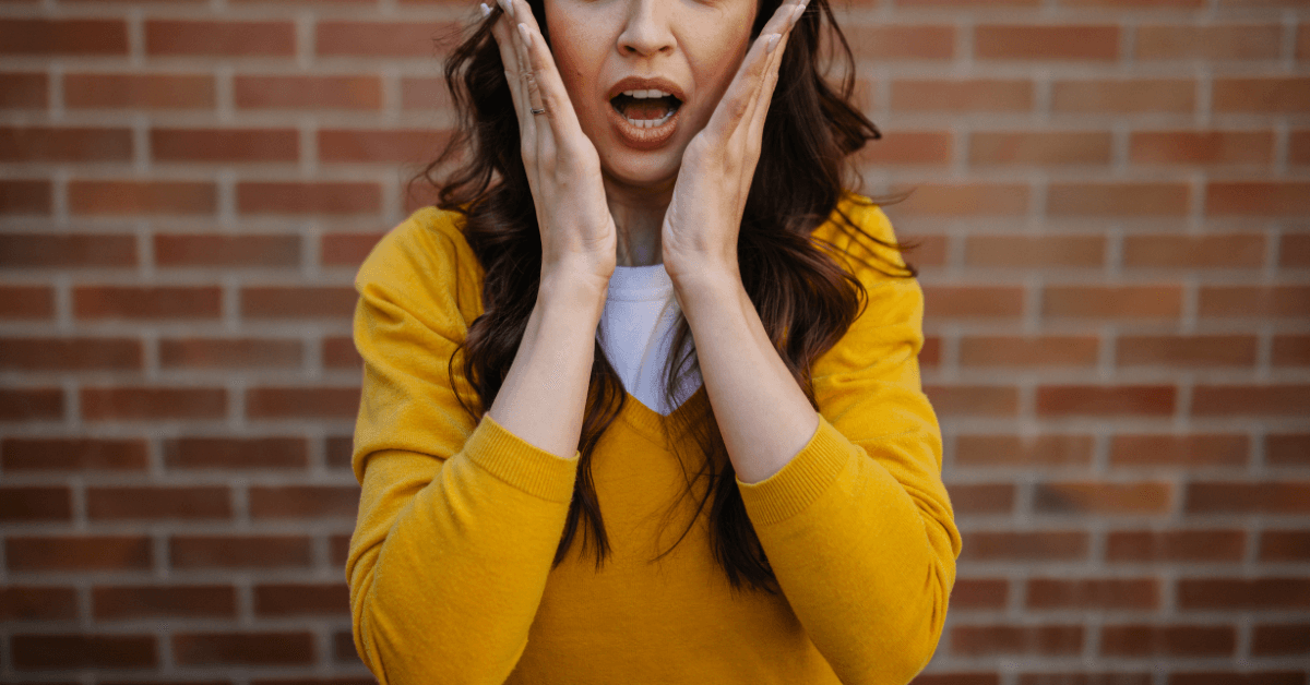 surprised woman with hands on her face