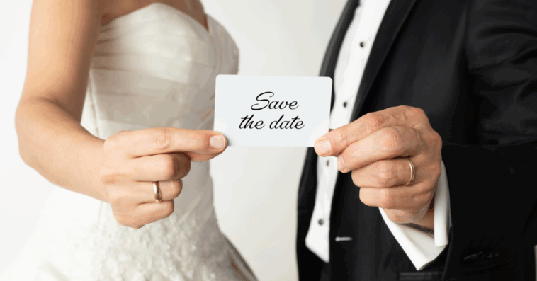 Couple holding up 'Save the Date!' card