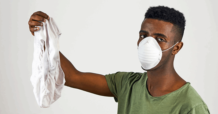 Disgusted guy holding up underwear