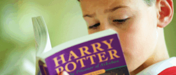 Boy reading 'Harry Potter'