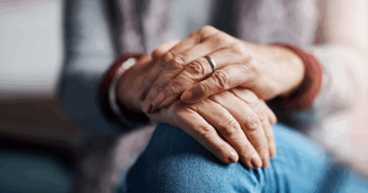 The hands of an older woman resting on our knees.