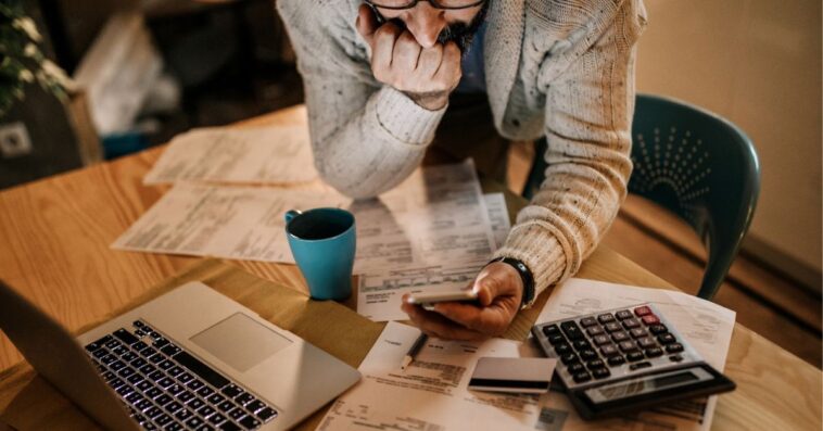 Man using phone to see price predictions.