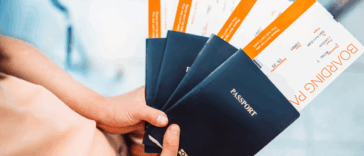 A person holding a fan of passports.