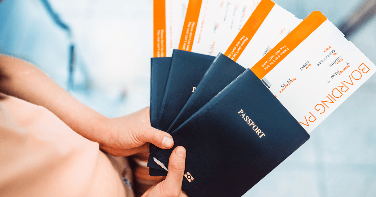 A person holding a fan of passports.