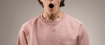 A man with facing forward with his mouth wide open.