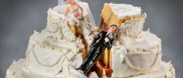 Bride and groom figurines collapsed in a ruined wedding cake.