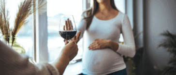 pregnant woman refusing a glass of wine