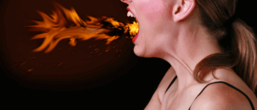 A woman breathing fire from her mouth.