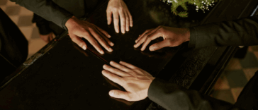 hands on a casket lid