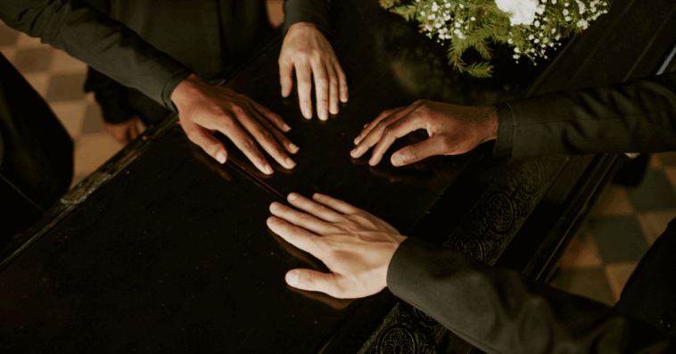 hands on a casket lid