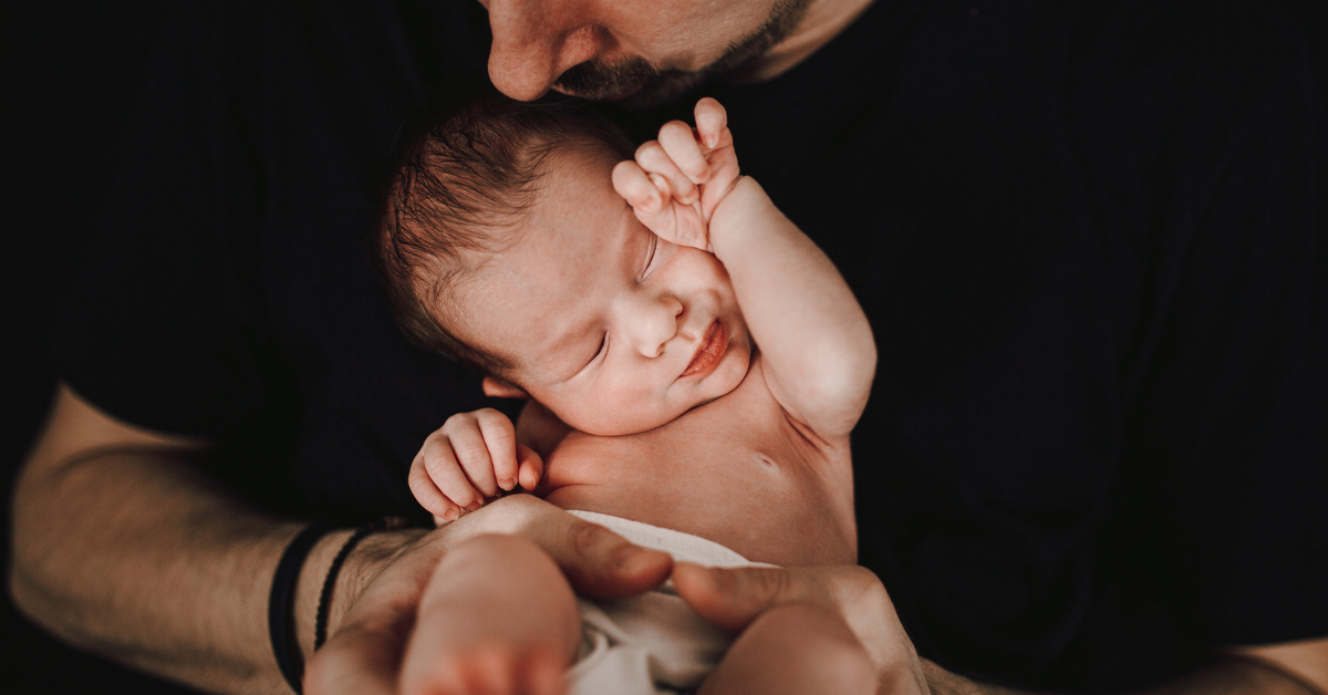 father holding infant