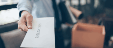 person handing in a resignation letter