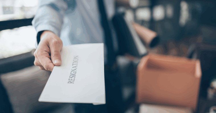 person handing in a resignation letter