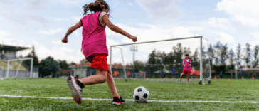 girl practicing soccer