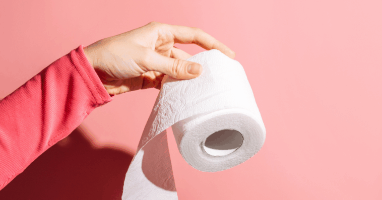 Person holding a roll of toilet paper