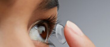 Close-up of a woman putting in a contact lens.