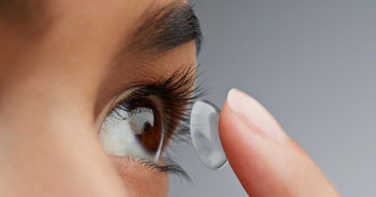 Close-up of a woman putting in a contact lens.