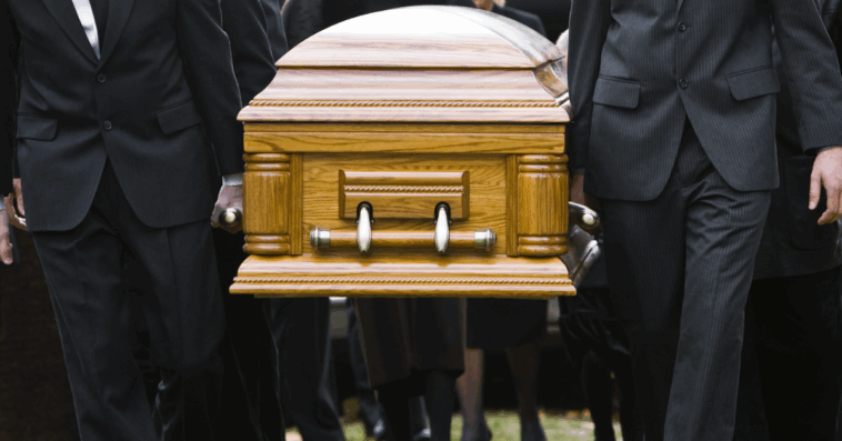 A group of pallbearers carrying a casket.