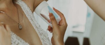The Maid Of Honor Applies Antiperspirant To The Bride's Armpits.
