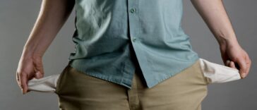 A man showing his empty pockets.