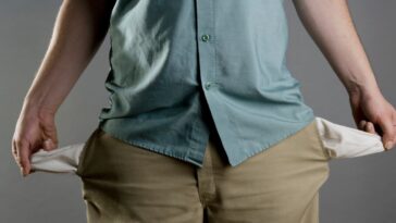 A man showing his empty pockets.