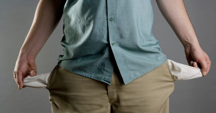 A man showing his empty pockets.