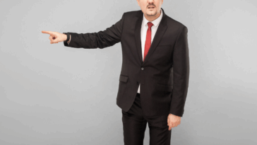 A pan pointing for someone to go.