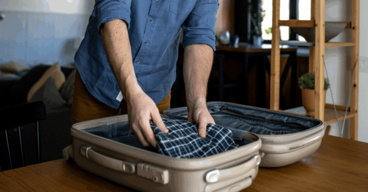Man packing suitcase