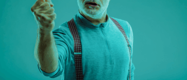 A man shaking his arm in a tinted green glaze.