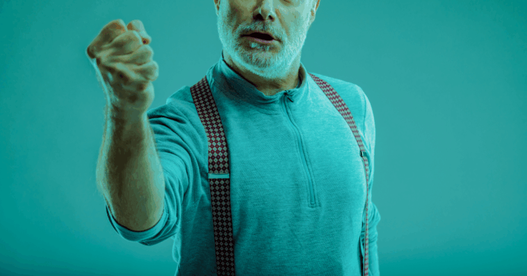 A man shaking his arm in a tinted green glaze.