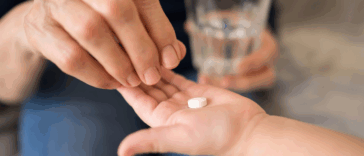 Child taking a melatonin pill