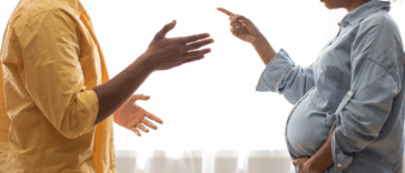 Man and pregnant woman arguing