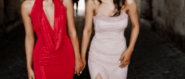 One woman in a red dress and one woman in a white dress.