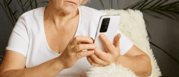 An older woman looking at a cell phone.
