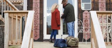 Mature couple arriving for a glamping weekend at an eco lodge.They are unlocking the door on arrival.