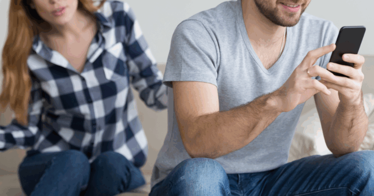 Man and woman arguing over cell phone