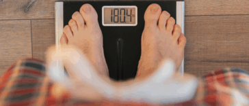 A person standing on a scale.