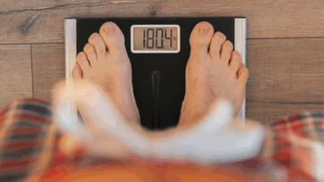 A person standing on a scale.
