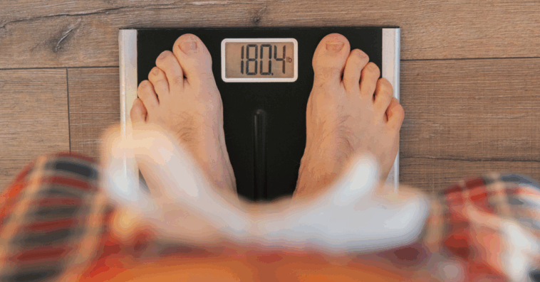 A person standing on a scale.