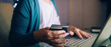 older woman entering credif card information online