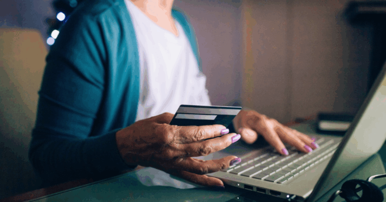 older woman entering credif card information online