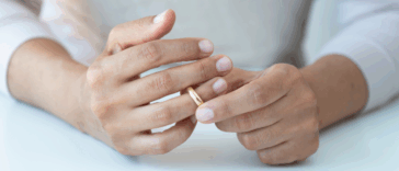 woman removing her wedding ring
