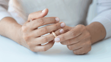 woman removing her wedding ring