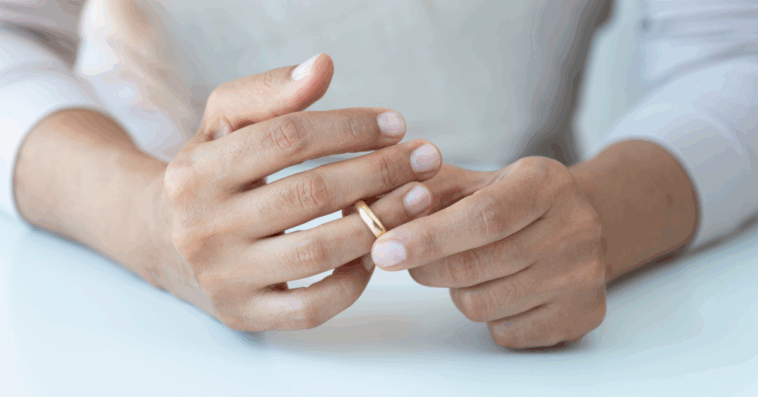 woman removing her wedding ring