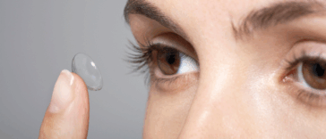 Woman putting in contact lenses