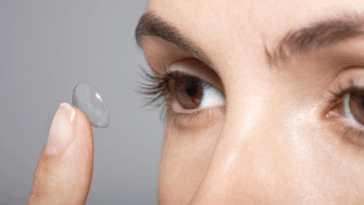 Woman putting in contact lenses