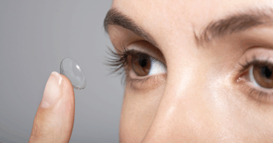 Woman putting in contact lenses