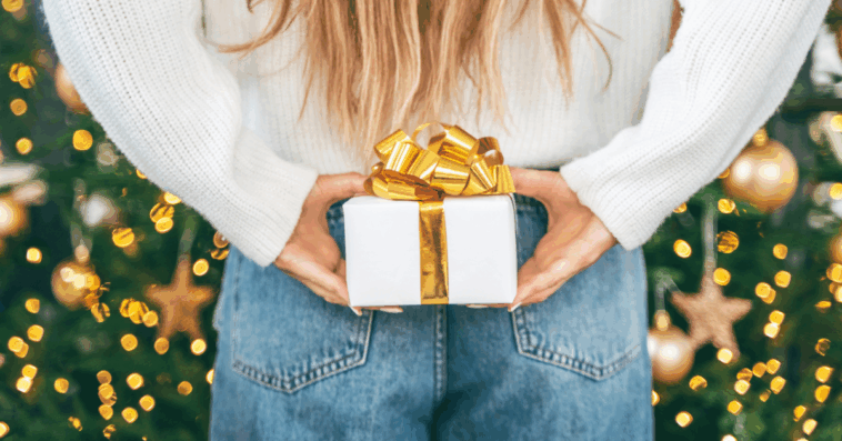 person holding wrapped gift behind their back